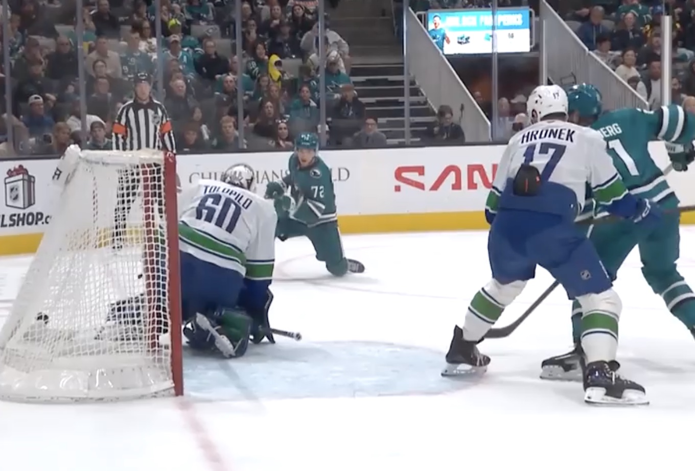 The Sharks Will Smith rips a power play goal past Canucks goalie Nikita Tolopilo.